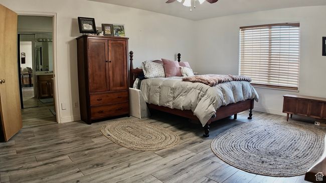 Bedroom with ceiling fan, baseboards, and wood finished floors | Image 41