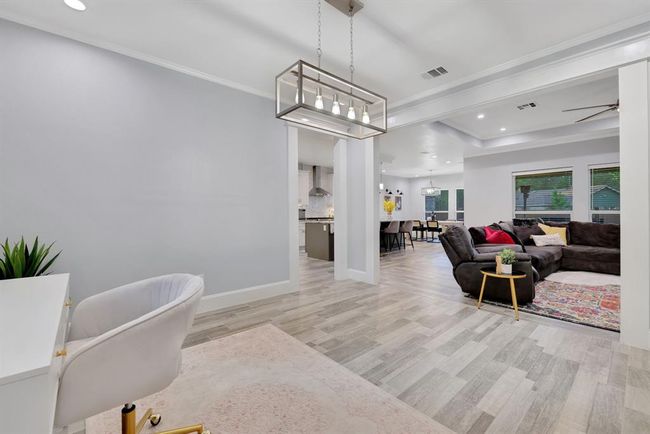 Stunning open-concept view encompassing the living room, kitchen, flex space, and grand entry—perfectly designed for both elegance and functionality. | Image 11