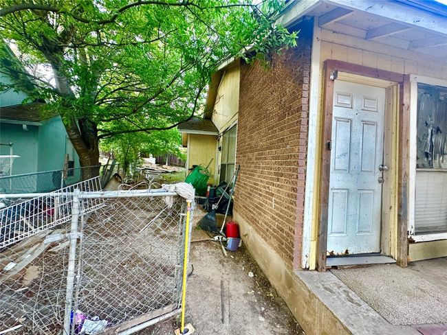 View of home's exterior featuring brick siding and a gate | Image 22