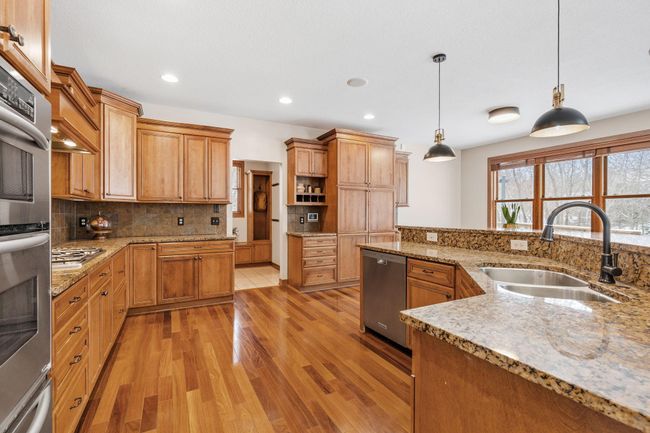 The spacious kitchen is complete with stainless steel appliances, granite countertops and ample storage! | Image 13