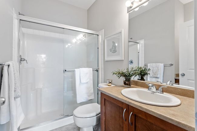 Bathroom with toilet, two separate vanities and a stall shower | Image 30