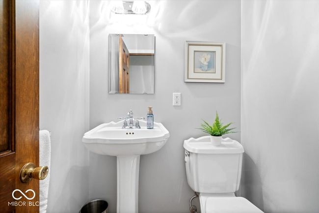 half bathroom featuring toilet and a sink | Image 10