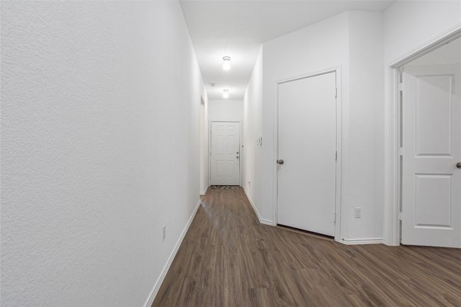 Hall with baseboards and dark wood-style flooring | Image 4