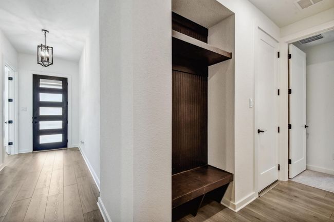 Mudroom featuring wood finished floors and a chandelier | Image 20