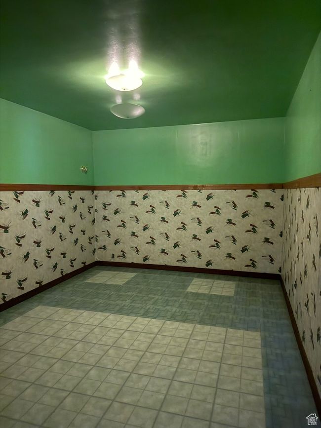 Empty room with a wainscoted wall and wallpapered walls | Image 28