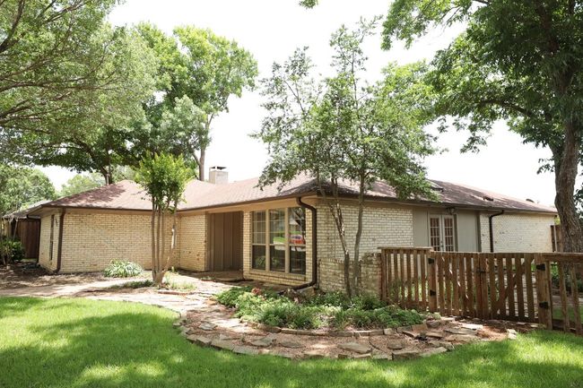 Rear view of property with brick siding, a chimney, and a lawn | Image 38