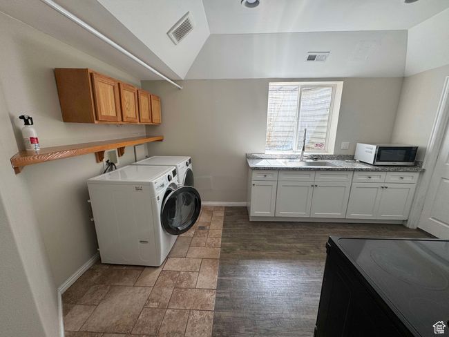 Laundry room with washer and dryer, baseboards, and cabinet space | Image 15