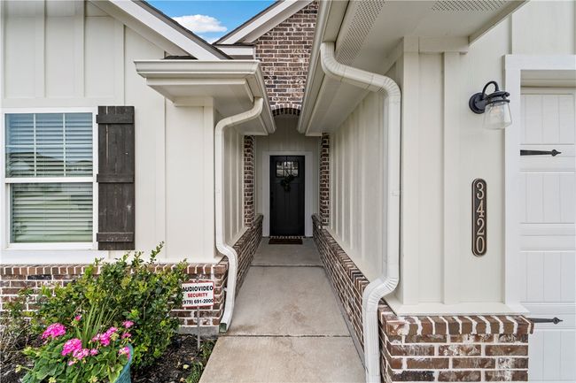 View of exterior entry featuring board and batten siding | Image 31
