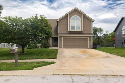 View of front of home with a garage and a front yard | Image 2