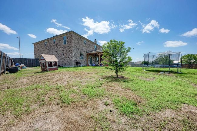 Fenced backyard with a trampoline and a shed | Image 34