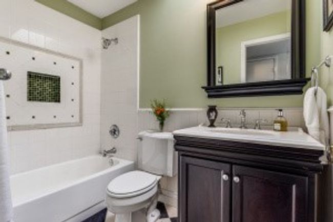 Full bathroom with wainscoting, toilet, vanity, and washtub / shower combination | Image 17