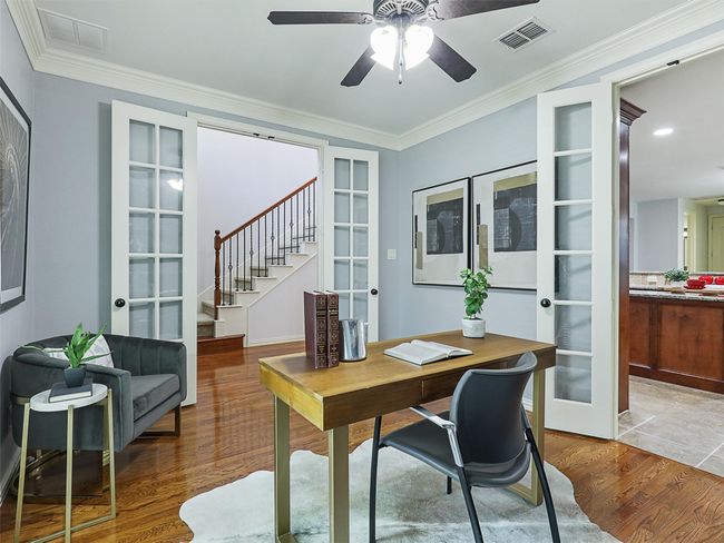 Home office with french doors, wood finished floors, a ceiling fan, and ornamental molding | Image 7