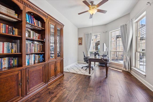 Office area featuring dark wood finished floors, baseboards, and a ceiling fan | Image 17