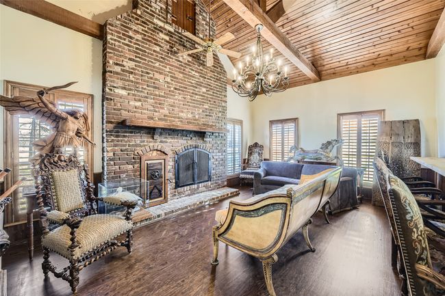 Full of character, the family room has bead board ceilings, matching shutters, and a floor to ceiling brick fireplace! | Image 30