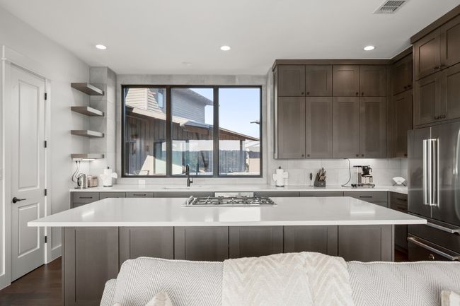 Modern Shaker style cabinetry that extends to the ceiling provides plentiful storage and a beautiful design. | Image 9