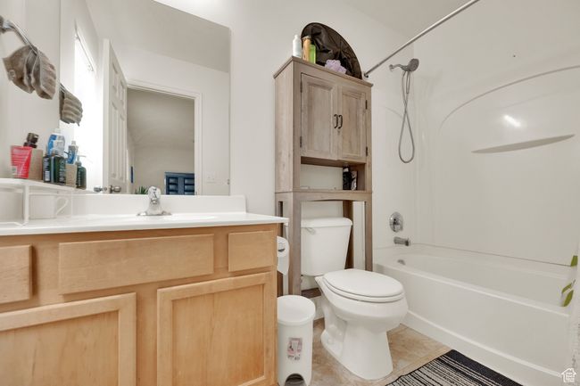 Full bathroom featuring vanity, bathtub / shower combination, and tile patterned floors | Image 14
