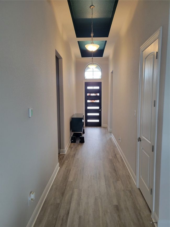 Hallway featuring baseboards and wood finished floors | Image 9