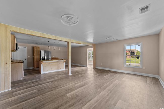 Unfurnished living room featuring wood finished floors | Image 19