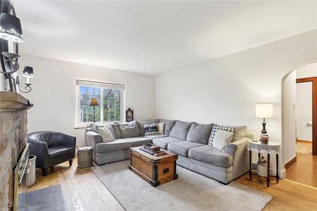 Living area featuring arched walkways and wood-type flooring | Image 6