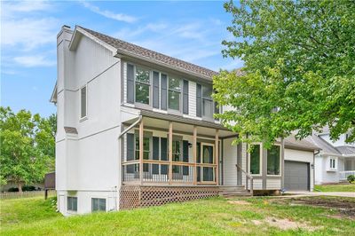 View of front of house with a garage, a front lawn, and a porch | Image 2