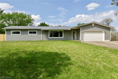 Ranch-style home featuring a front yard and a garage | Image 2