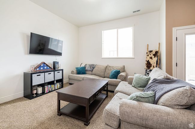 Carpeted living room with baseboards and visible vents | Image 8