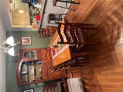 Dining space with light hardwood / wood-style floors and a chandelier | Image 3