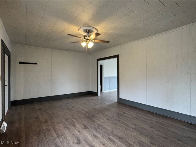 Spare room with crown molding, dark hardwood / wood-style floors, and ceiling fan | Image 8
