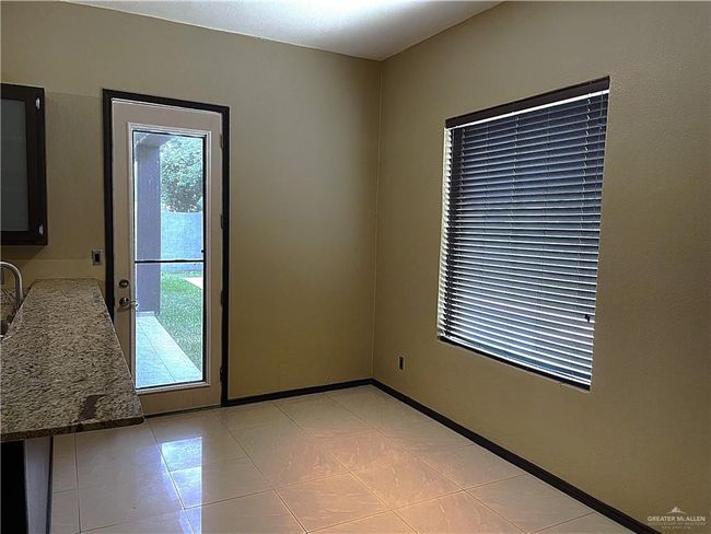 Empty room with light tile patterned flooring | Image 9