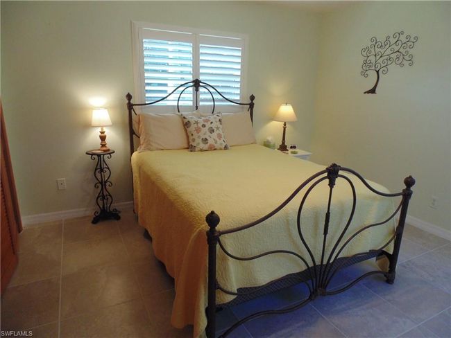 Bedroom featuring light tile patterned flooring and baseboards | Image 23