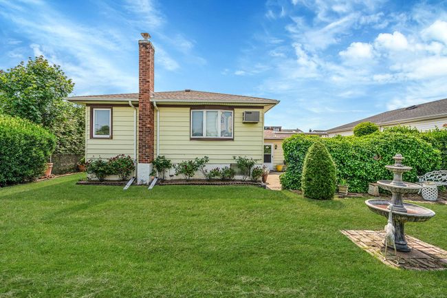 Rear view of property featuring an AC wall unit | Image 29