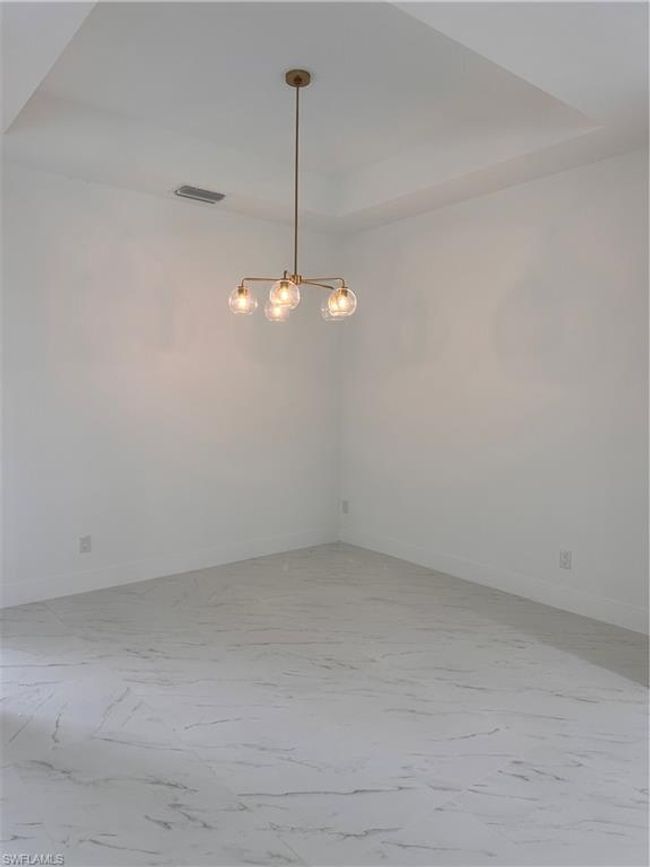 Spare room with a raised ceiling | Image 9