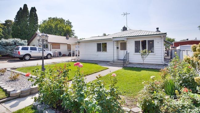 View of front facade featuring a metal roof, a chimney, and entry steps | Image 8