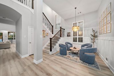 The soaring two-story foyer creates a grand entrance, welcoming you with natural light and open space. | Image 2