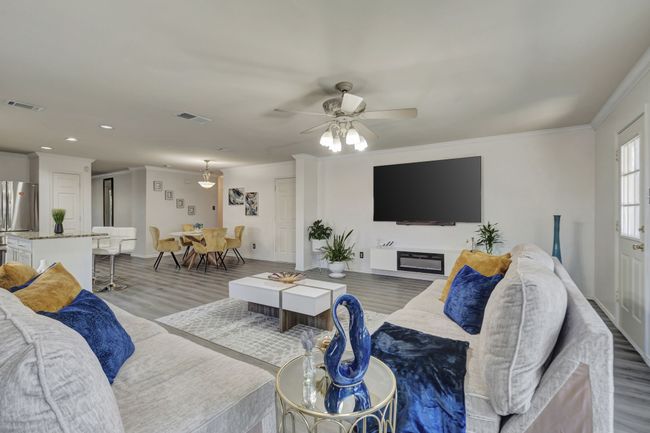 Living room featuring ceiling fan, hardwood / wood-style flooring, and crown molding | Image 19