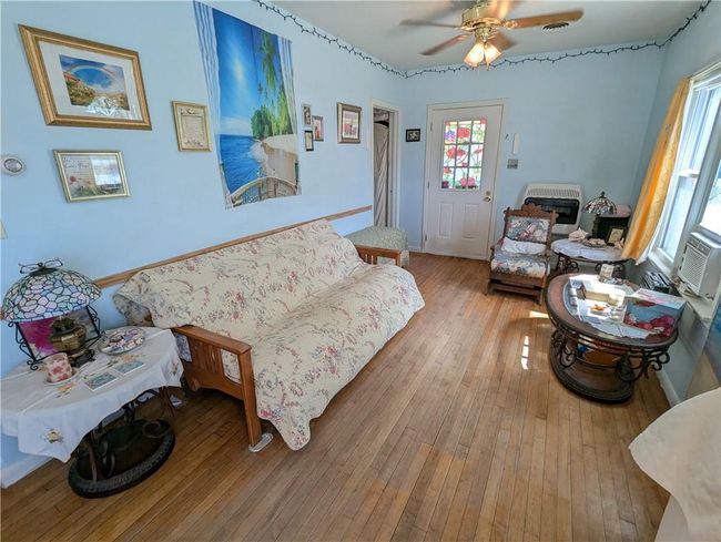 Living area with ceiling fan, baseboards, and hardwood / wood-style floors | Image 13
