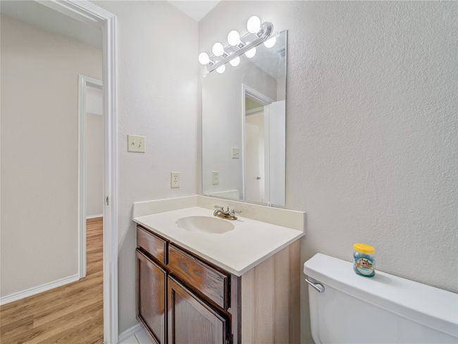 Bathroom with wood finished floors, toilet, vanity, and baseboards | Image 21