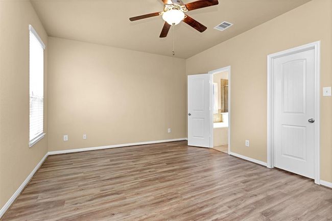 Generously sized, this retreat easily accommodates a king-size furniture suite while offering plenty of space to personalize your layout. Completing the suite is a spa-like ensuite bathroom, perfect for relaxation and luxury. | Image 13