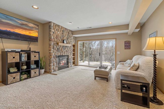 Lower level walkout to a patio that overlooks a wooded area behind the property. | Image 21