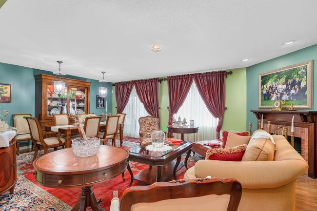 The Living Room offers a fireplace and is open the Dining Area. | Image 6