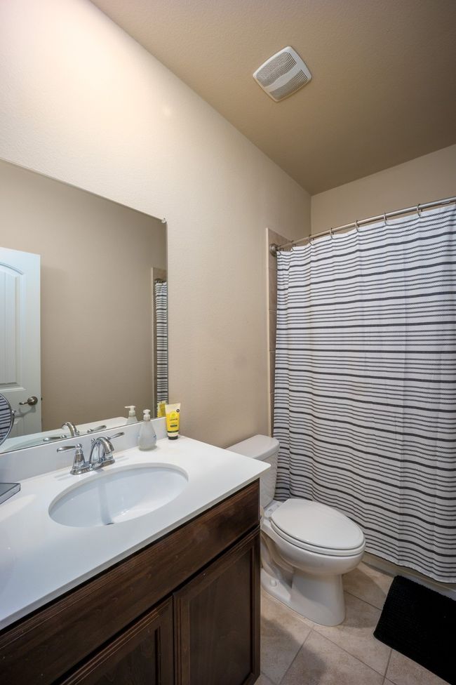 Full bathroom featuring tile patterned flooring, vanity, and a shower with shower curtain | Image 20