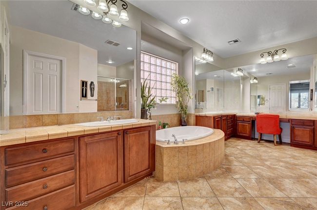 Full bath with two vanities, a stall shower, and a garden tub | Image 32