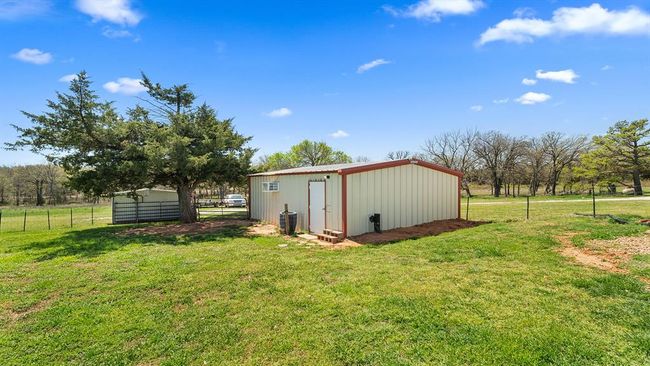 View of pole building featuring a yard and fence | Image 7