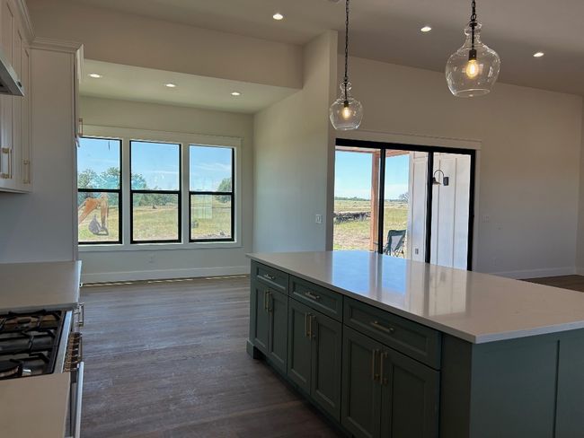 Kitchen featuring baseboards, light countertops, gas range, dark wood-type flooring, and recessed lighting | Image 8