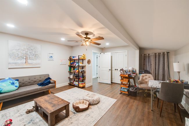 Living room with baseboards, wood finished floors, a ceiling fan, and recessed lighting | Image 6