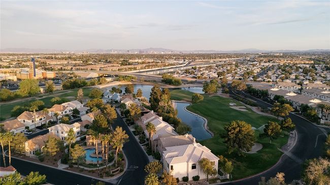 Aerial view of property's location with a water and mountain view, nearby suburban area, and a golf course | Image 46