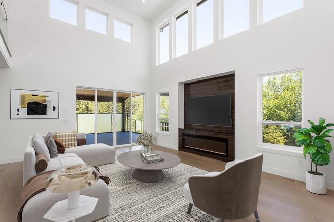 Living room featuring visible vents, baseboards, and wood finished floors | Image 7
