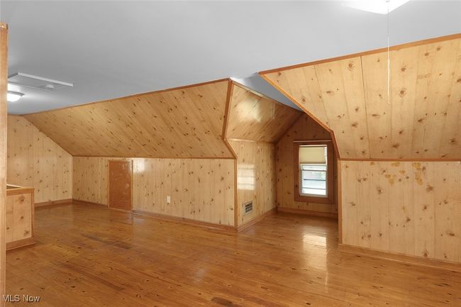 primary bedroom featuring wood flooring, visible vents, and lofted ceiling | Image 20