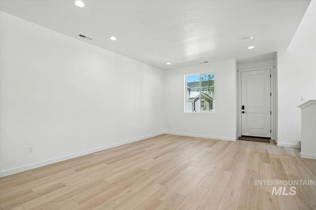 Empty room with light wood-type flooring and recessed lighting | Image 7