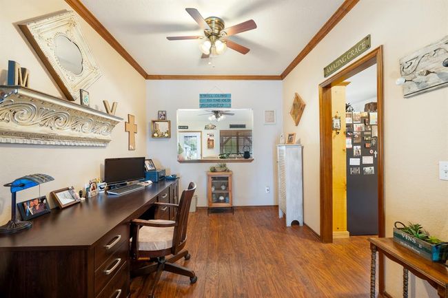 Home office featuring baseboards, ceiling fan, ornamental molding, and dark wood-type flooring | Image 12